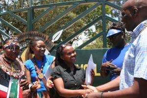 Ann Njeri receiving the International Women's Day award,  presented by the President of Rotary Club Mombasa