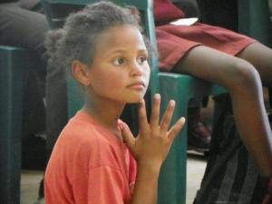A young girl learning about prayer (Photo: Jackie Euvrard)